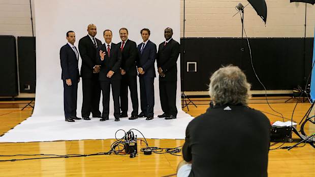 Atlanta Hawks head coach Mike Budenholzer (third from left) and his staff pose for team photographer Scott Cunningham during media day at Philips Arena.